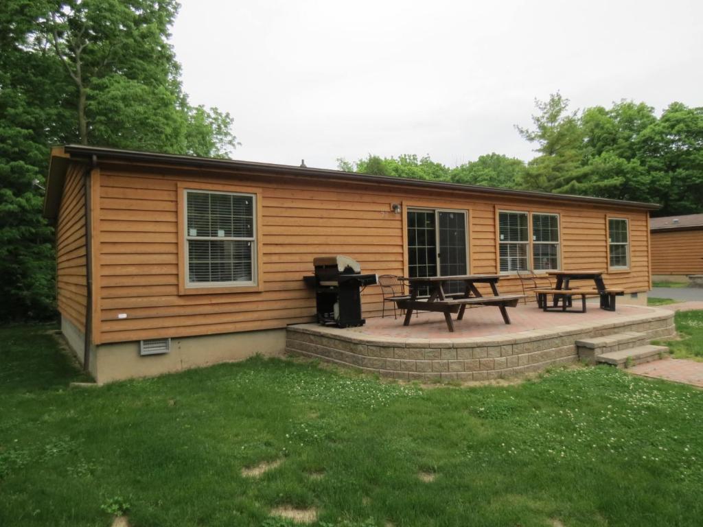 Cabaña de madera con mesa de picnic y parrilla en Island Club #77, en Put-in-Bay