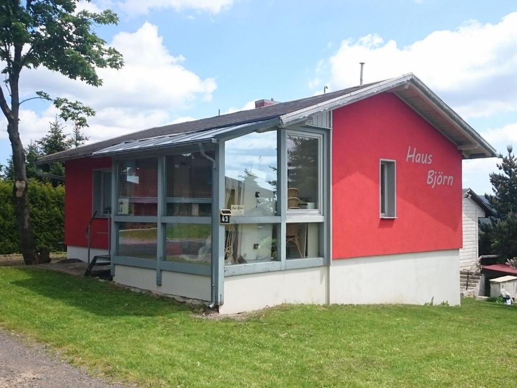 a red and white building with a window at Wellness Home with Garden in Schnett