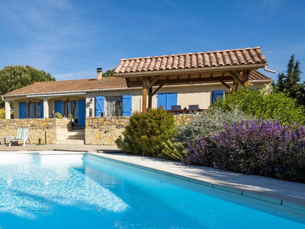 a house with a swimming pool in front of a house at Luxury villa with pool in Malvi s in Malviès