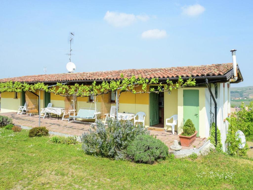 ein Haus mit einer Terrasse mit Stühlen und Reben in der Unterkunft Belvilla by OYO Casa Reale Quattro in Valdamonte