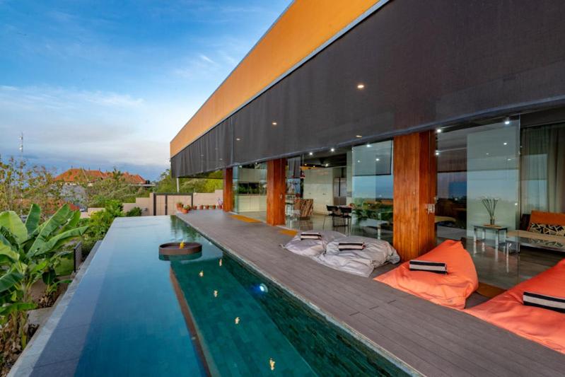 a house with a swimming pool in front of it at The Arancia Villa in Nusa Penida