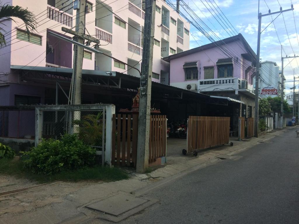 un tren está estacionado en una calle al lado de los edificios en Thanya Mansion en Kanchanaburi