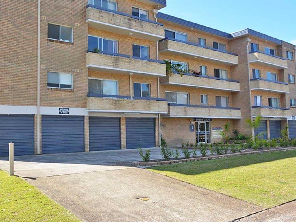 a large brick building with two garage doors at Silvana Court 3 neat unit with air conditioning in Shoal Bay