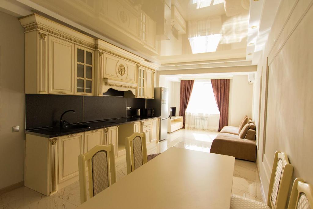 - une cuisine avec une table, des chaises et un canapé dans l'établissement Residential Complex Central 261, à Almaty