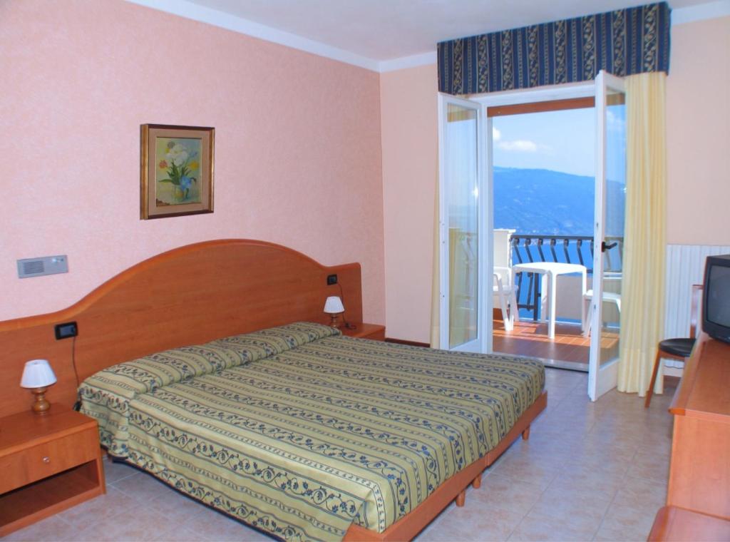 Postel nebo postele na pokoji v ubytování Hotel Residence La Rotonda