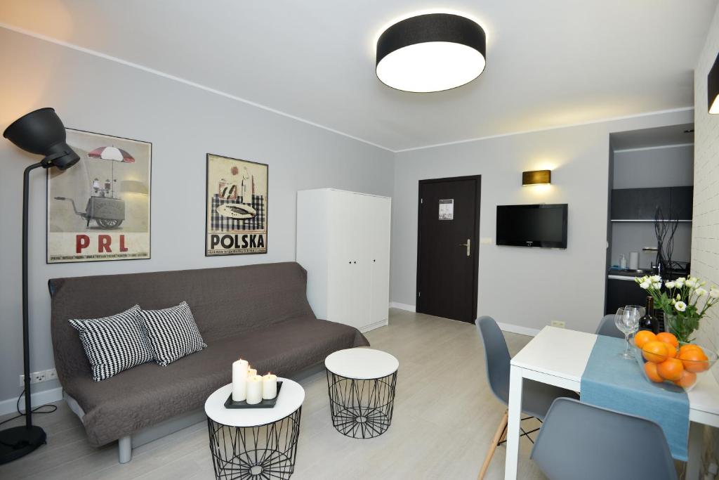 a living room with a couch and a table at Apartamenty TOP Garbary in Poznań