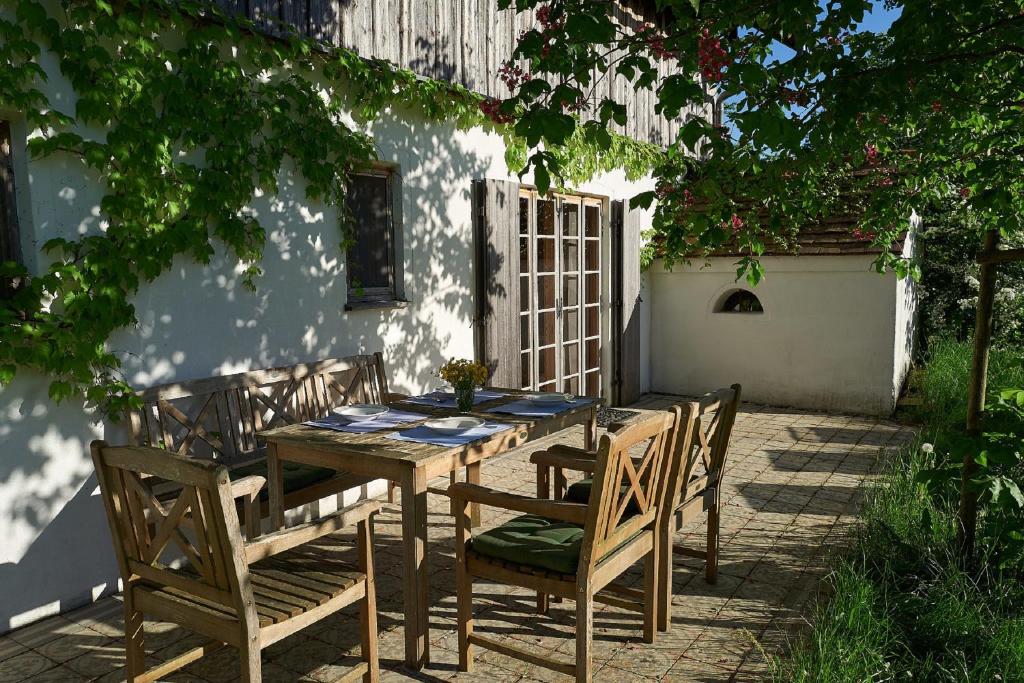 a wooden table and chairs on a patio at Ponzaunerhof in Hebertsfelden