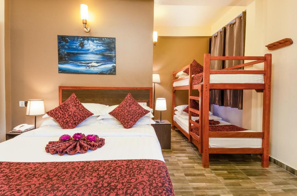 Postel nebo postele na pokoji v ubytování Paguro Beach Inn