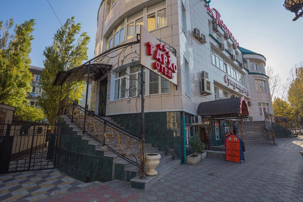 a building with a sign on the side of it at Tarkho Hotel in Makhachkala