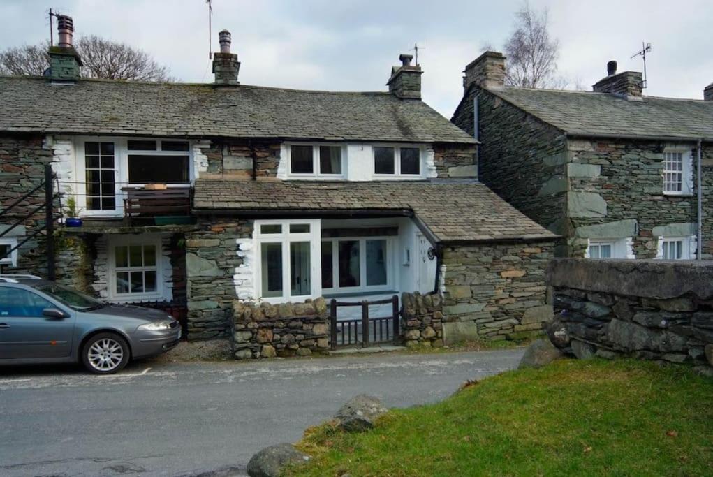 a stone house with a car parked in front of it at Pippins, Elterwater in Chapel Stile