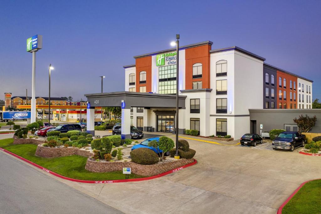 a building with a parking lot in front of it at Holiday Inn Express & Suites Longview North, an IHG Hotel in Longview