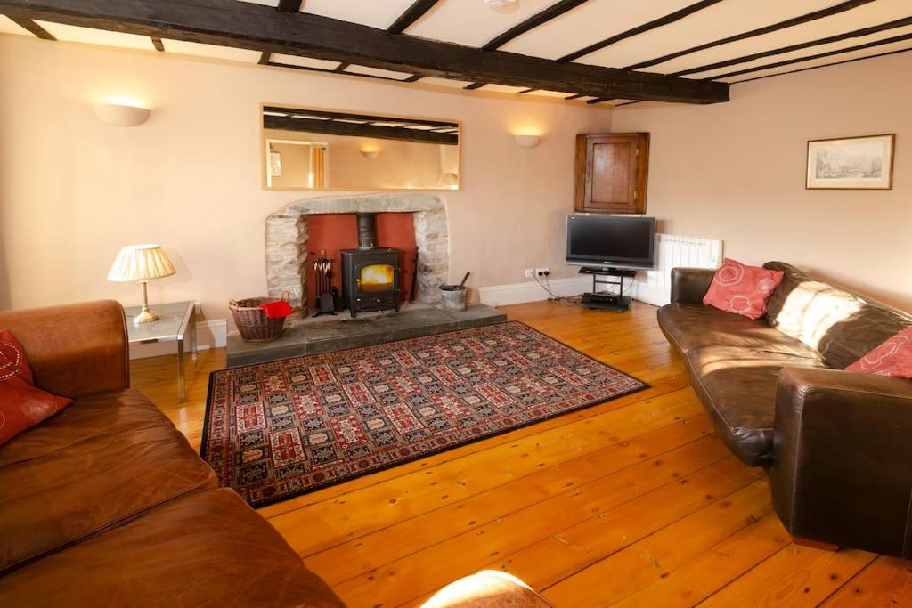 a living room with a couch and a fireplace at The Old White Lion, Chapel Stile in Chapel Stile