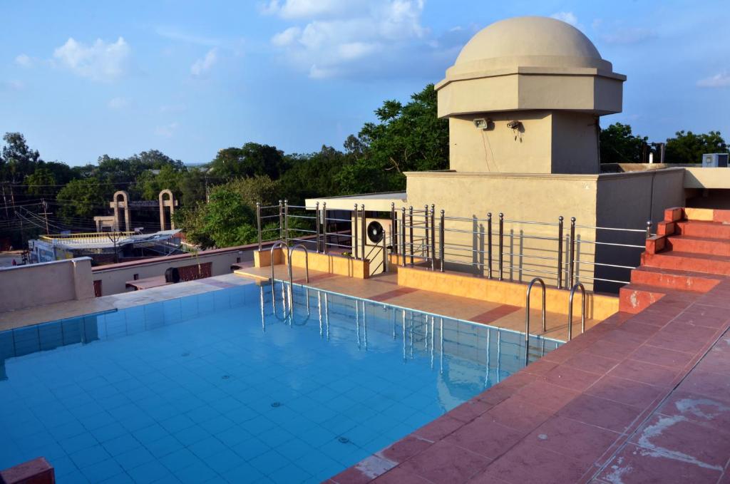 a swimming pool on the roof of a building at Hotel Bhoomivilas in Agra