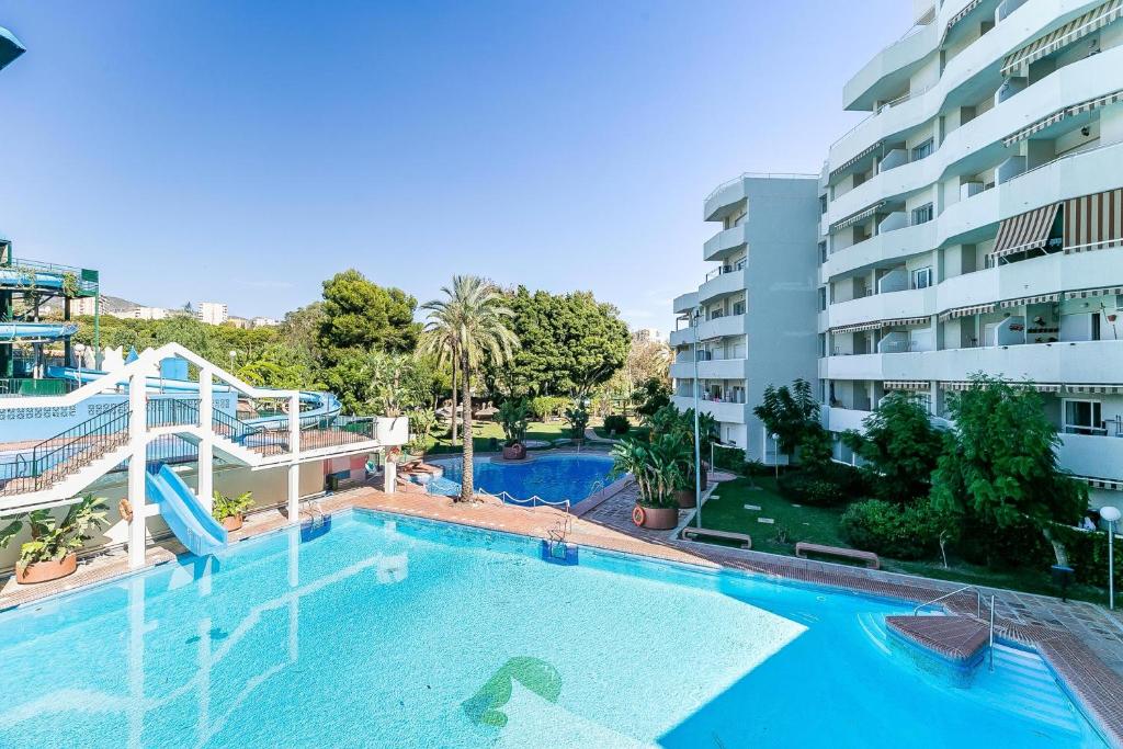 a large swimming pool in front of a building at Sea View Apartment in Benalmádena, Shared Pool in Benalmádena