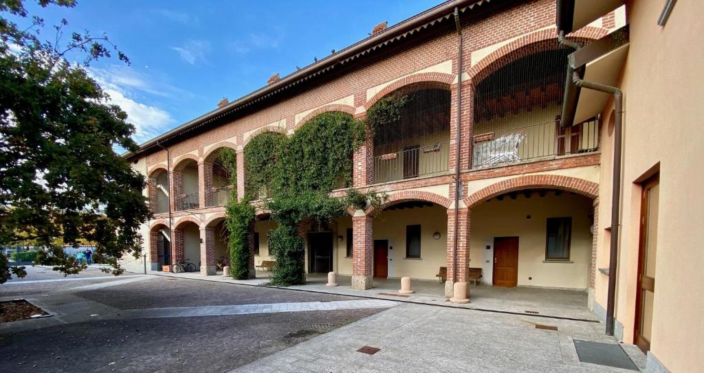 a building with ivy growing on the side of it at Cascina San Giovanni in Arcore