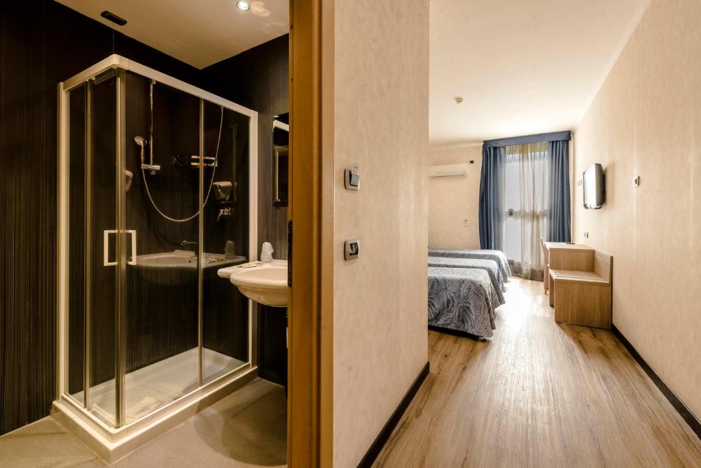 Postel nebo postele na pokoji v ubytování Hotel Roma Sud