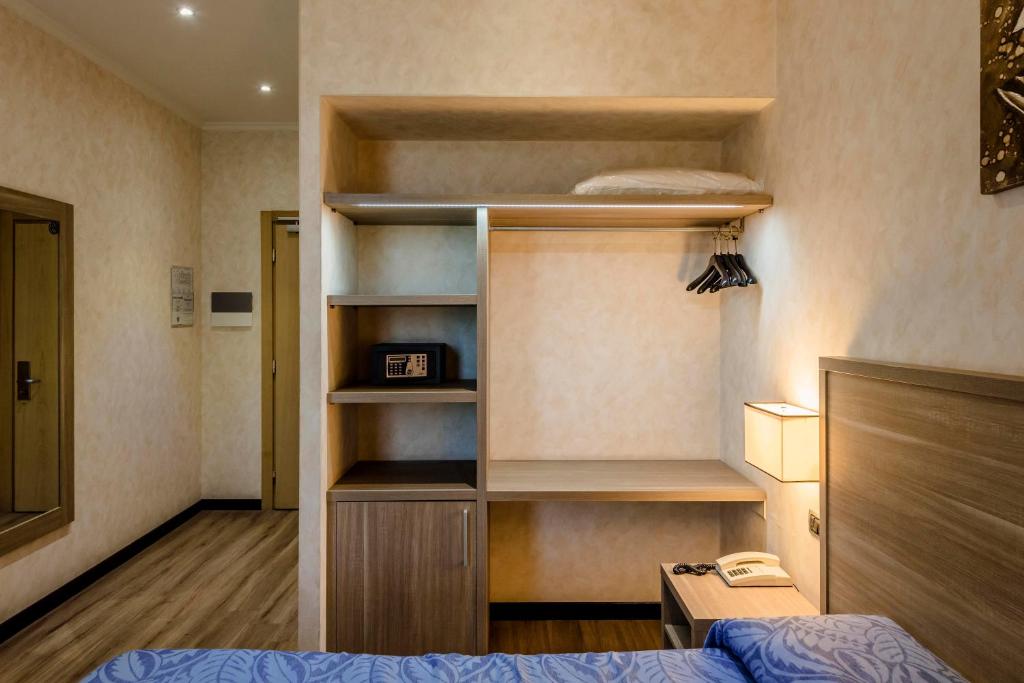 Postel nebo postele na pokoji v ubytování Hotel Roma Sud