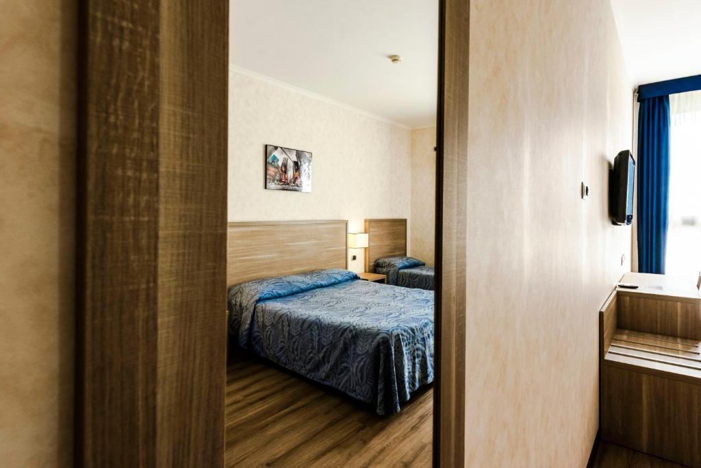 Postel nebo postele na pokoji v ubytování Hotel Roma Sud