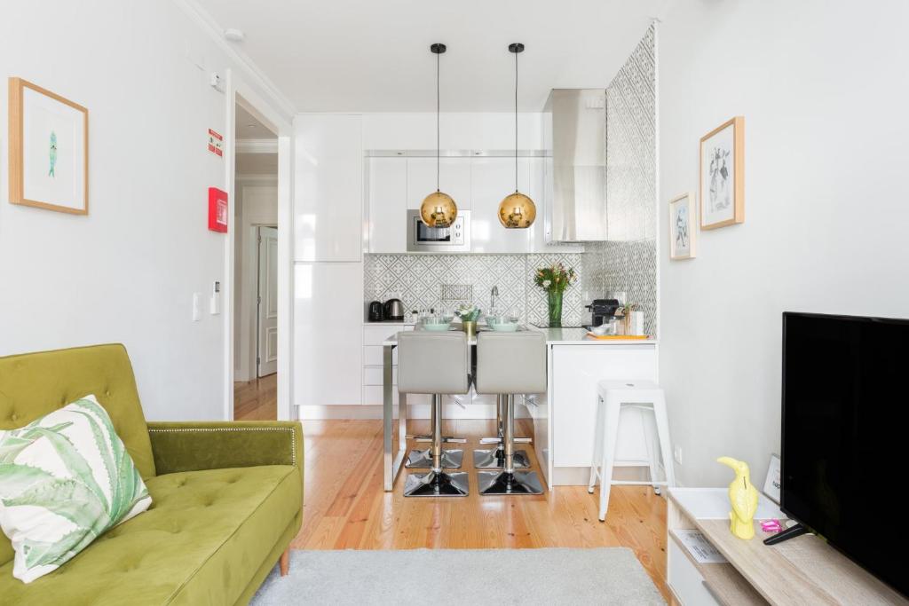 a living room with a couch and a kitchen at Augusta Street 213 - 3 Esq in Lisbon