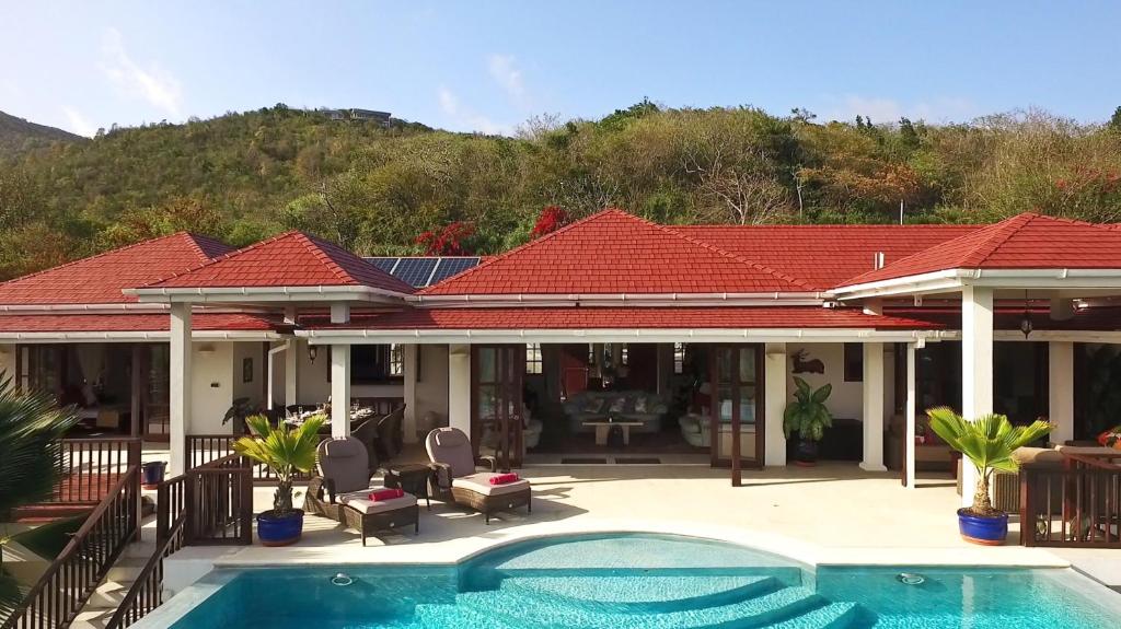 a house with a swimming pool in front of it at IJEOMA HOUSE in Bequia