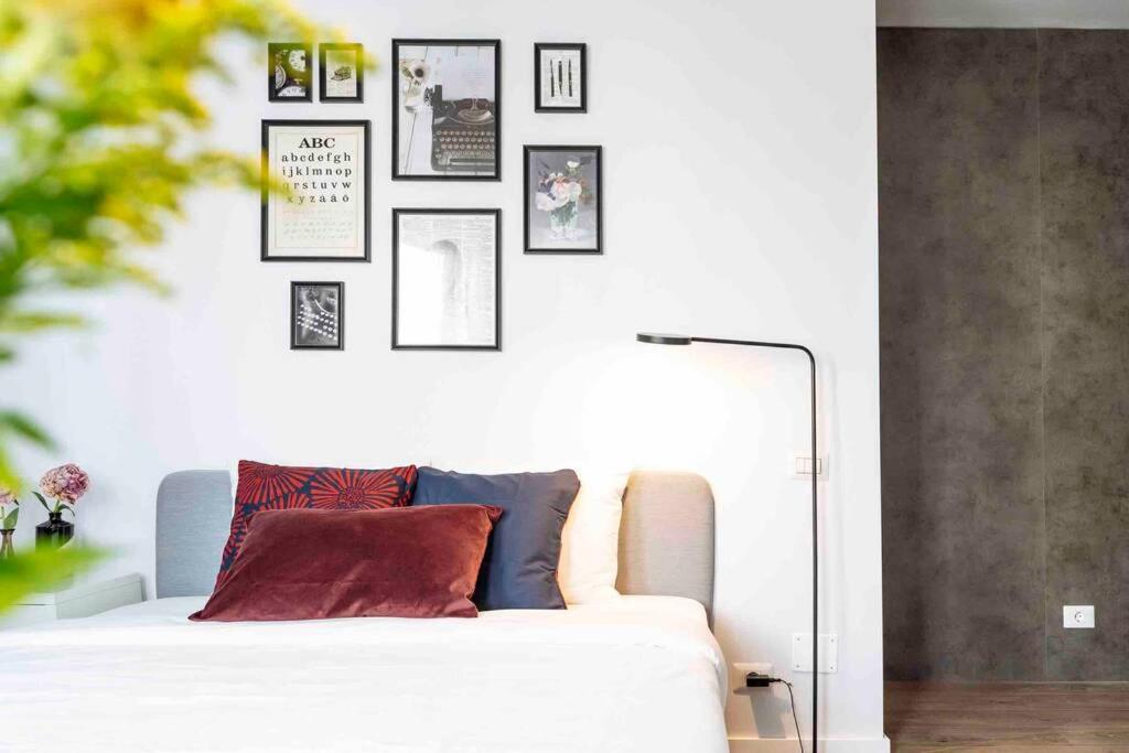 a white couch in a room with pictures on the wall at Beautiful Studio - Top Location - Netflix in Bucharest