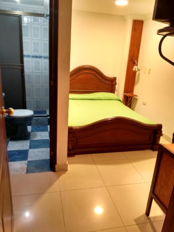 Postel nebo postele na pokoji v ubytování Hotel Ejecutivo Imperial