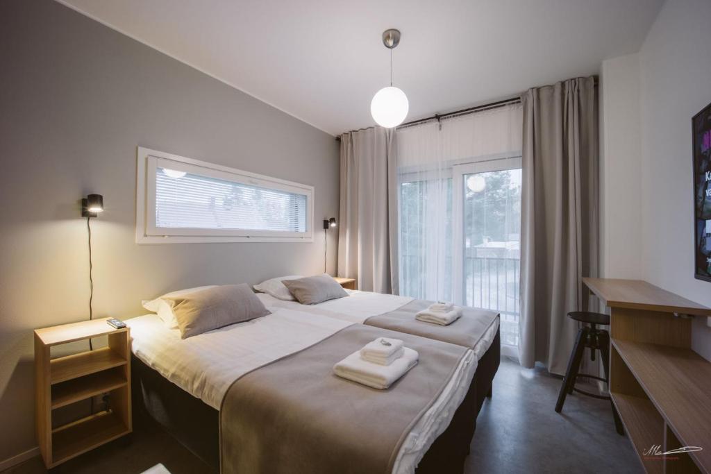 Ένα ή περισσότερα κρεβάτια σε δωμάτιο στο Villa Veromäki