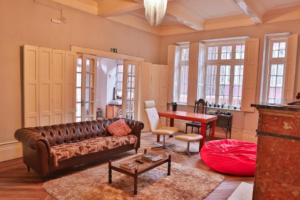 a living room with a couch and a table at Vila Santa Eulalia Hostel in Pelotas