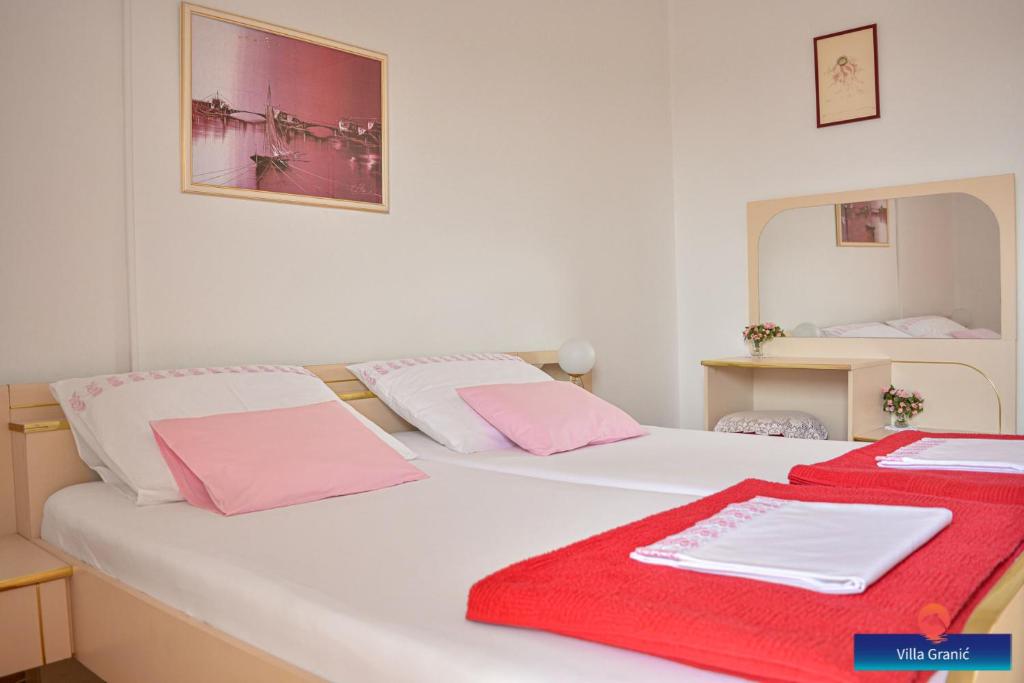 a white bed with pink and white towels on it at Villa Granić in Promajna