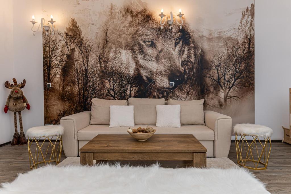 a living room with a wolf mural on the wall at Aki Studio Silver Mountain Poiana Brasov in Poiana Brasov