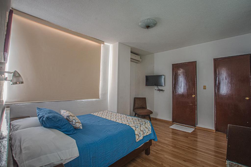 Postel nebo postele na pokoji v ubytování Hotel Palacio