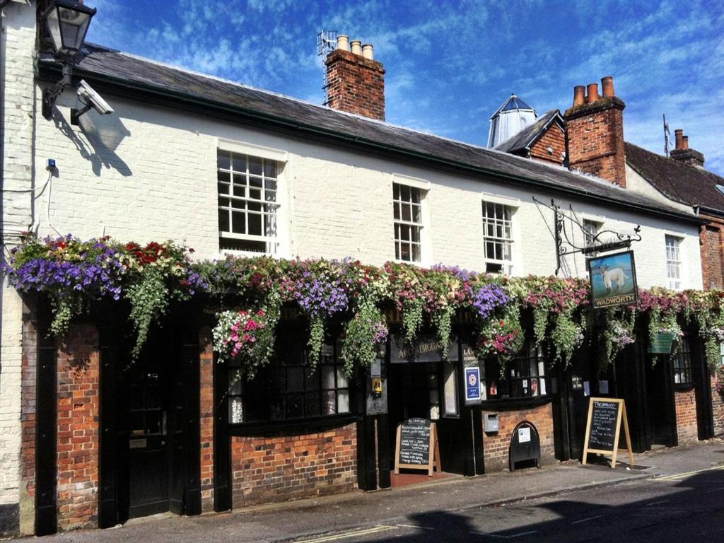 a building with flowers on the side of it at The Lamb Inn in Marlborough