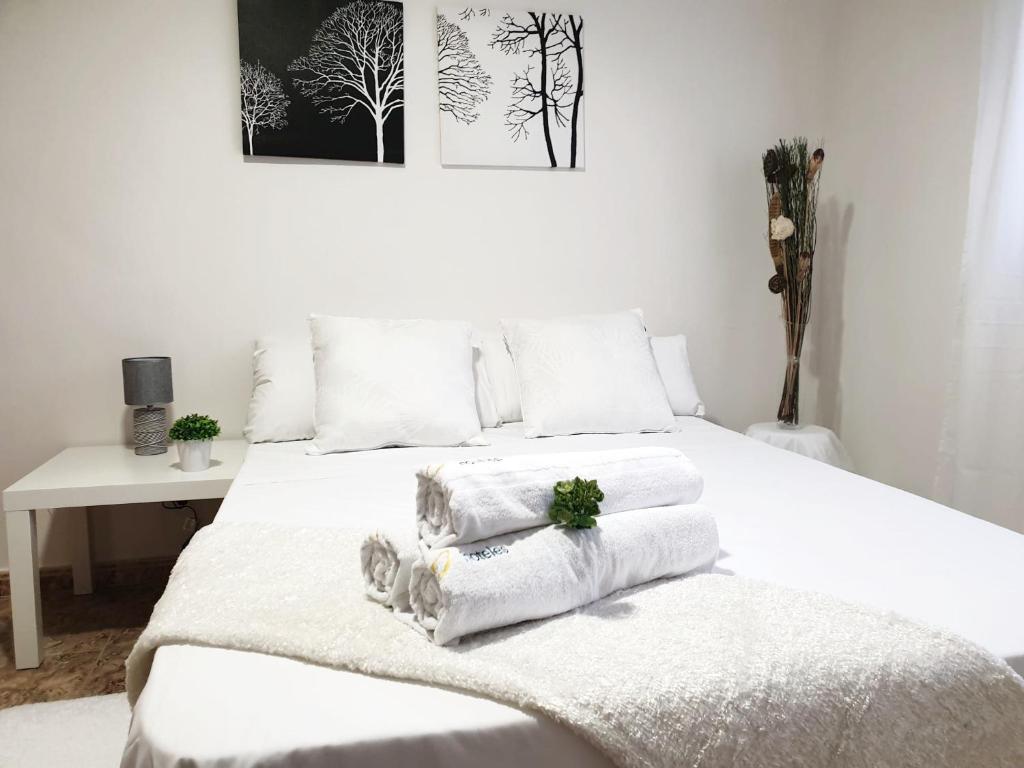 a bedroom with a white bed with towels on it at Hotel M5 Valencia Aeropuerto in Manises