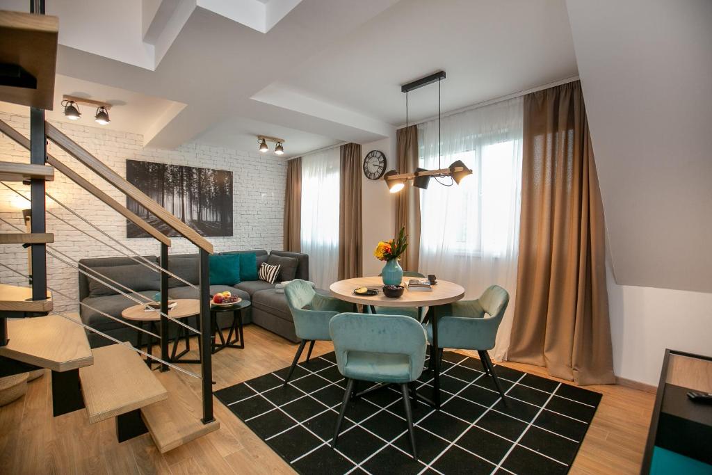 a living room with a table and a couch at The Greens Family Suit in Zlatibor