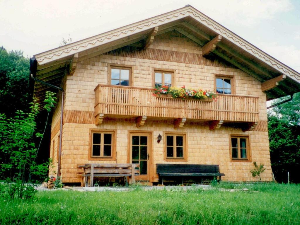 a small wooden house with a balcony on it at Cozy Chalet with Sauna in Gro arl in Grossarl
