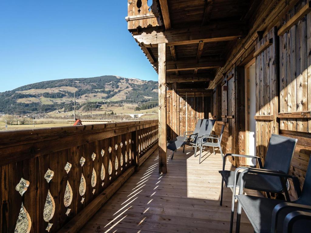 a wooden deck with chairs and a view of the beach at Apartment in Hollersbach with sauna near ski area in Hollersbach im Pinzgau