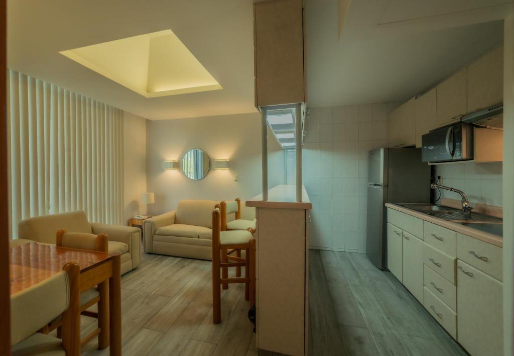 a kitchen and living room with a couch and a table at Suites Arquimedes 33 in Mexico City
