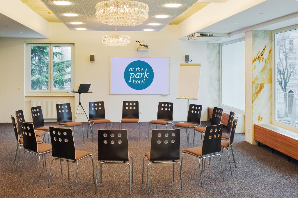 an empty room with chairs and a podium and a stage at At the Park Hotel in Baden
