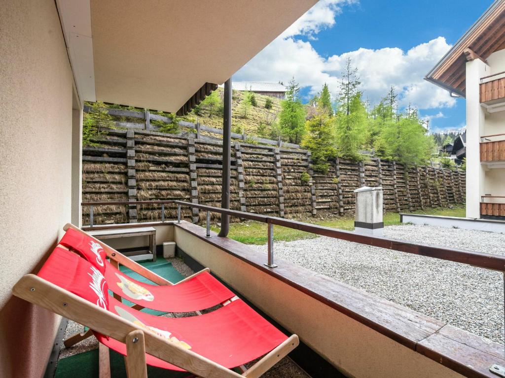 ゾンネンアルペ・ナスフェルトにあるSki in ski out apartment at Nassfeld in Carinthiaの家のバルコニー赤いベンチ