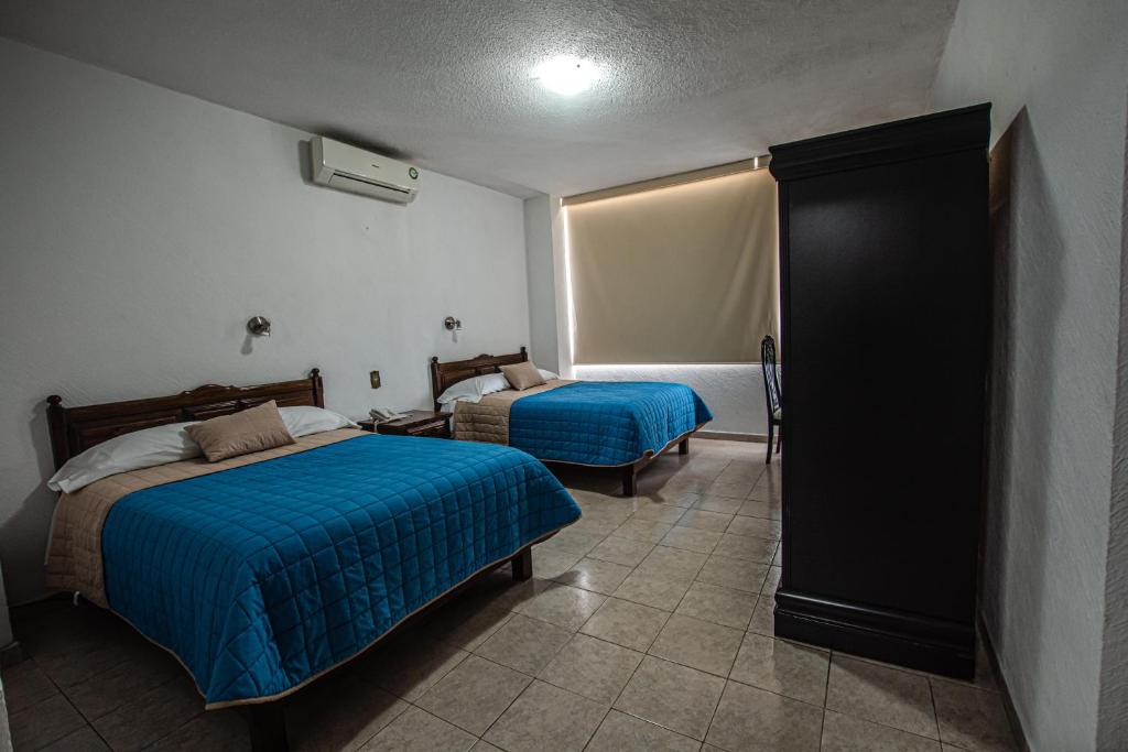 Postel nebo postele na pokoji v ubytování Hotel Palacio
