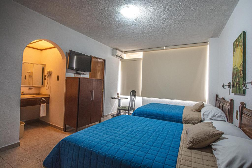 Postel nebo postele na pokoji v ubytování Hotel Palacio
