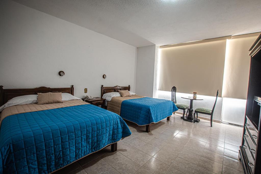 Postel nebo postele na pokoji v ubytování Hotel Palacio