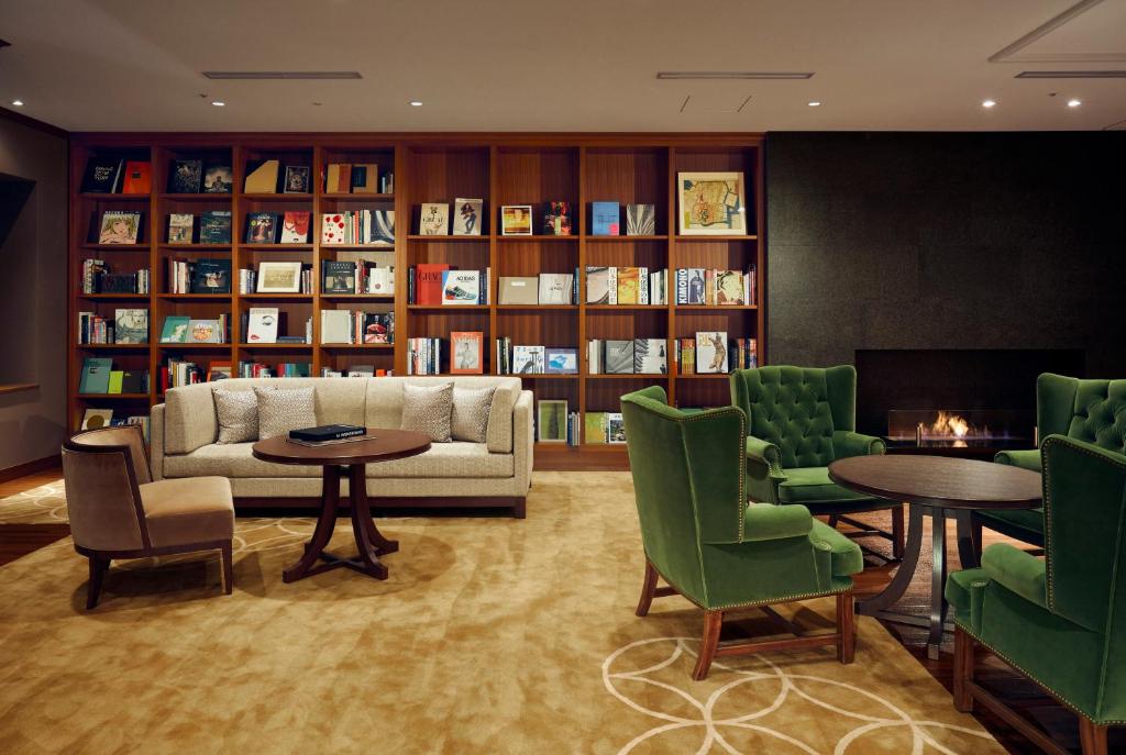a living room filled with furniture and a bookcase at Shiba Park Hotel in Tokyo