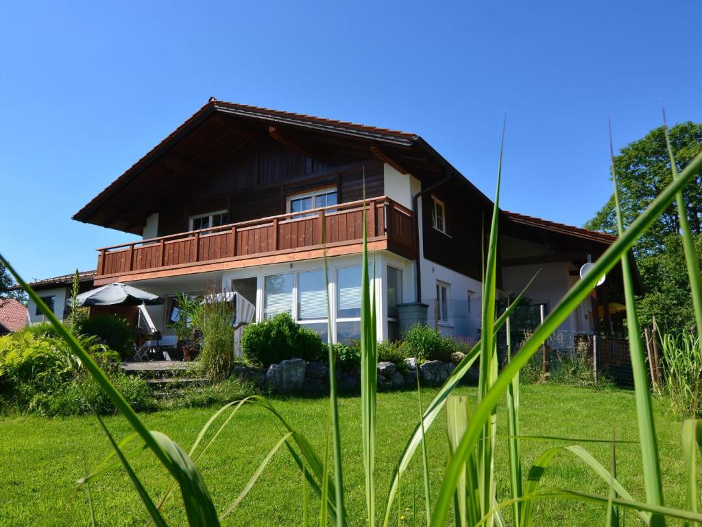 a house with a green yard with tall grass at Holiday home in Halblech near a ski resort in Halblech