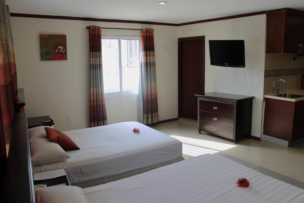 Postel nebo postele na pokoji v ubytování Curacao Suites Hotel