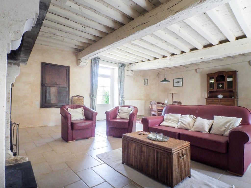 a living room with two couches and a coffee table at Holiday Home Saint-Laurent Pool Retreat in La Chapelle-Thémer