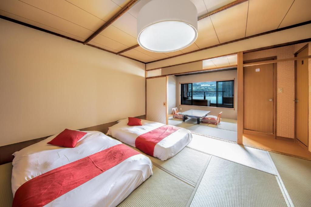 Postel nebo postele na pokoji v ubytování Inatori Akao Hotel