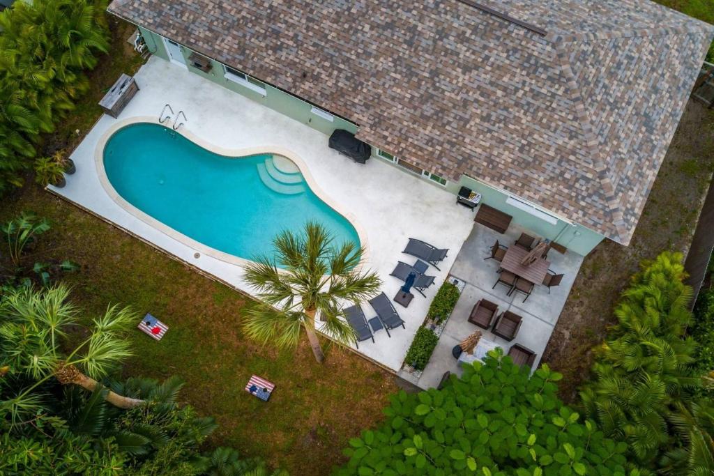 an overhead view of a swimming pool with chairs and a house at Sea Turtle in Marco Island