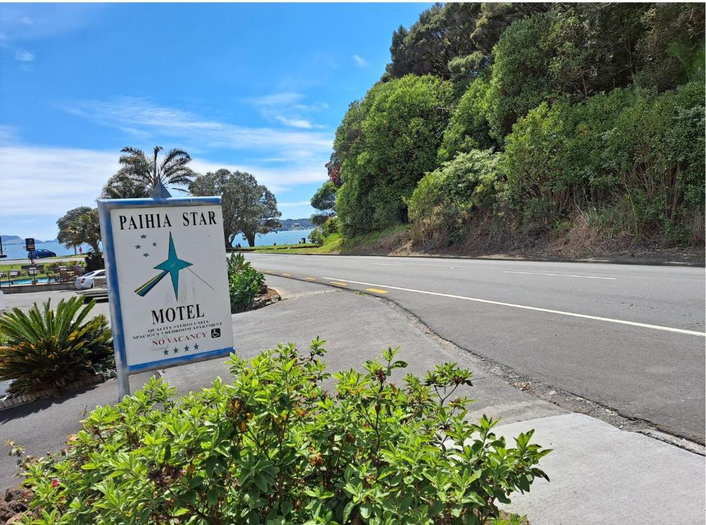 a sign for a mountain star world on the side of a road at Paihia Star Motel in Paihia