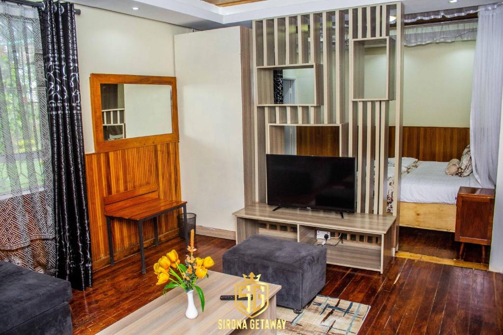Postel nebo postele na pokoji v ubytování Sirona Getaway Hotel